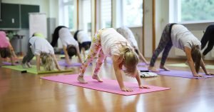kids doing yoga; blog: health benefits of yoga for kids